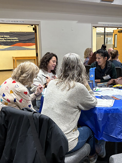 Women having bible study at table