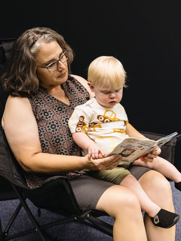 woman reading to toddler
