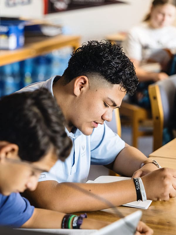 teenagers reading at table